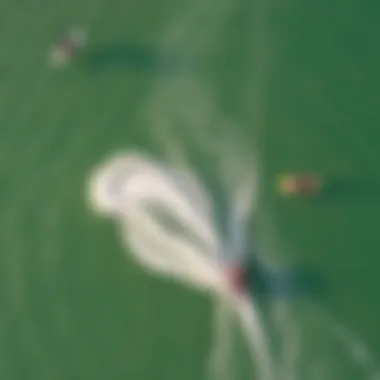 Aerial Kiteboarding Techniques Aerial view of kiteboarders demonstrating various techniques on water