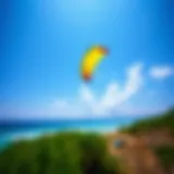 A vibrant kitesurfing trainer kite soaring in the sky over a picturesque beach