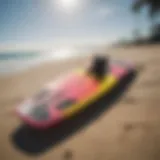 A vibrant Crazyfly kiteboarding board on the beach