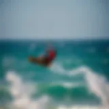 Kiteboarder soaring above the waves of El Pescadero
