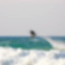 Kiteboarder soaring high above the waves