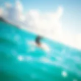Kite surfer gliding over turquoise waters