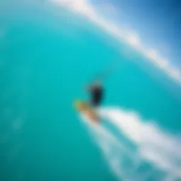 A breathtaking view of a kiteboarder soaring above clear blue waters, demonstrating the exhilaration of the sport.
