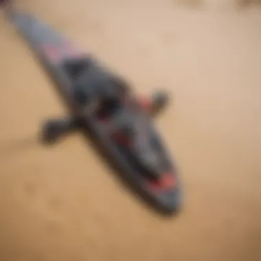 Close-up of high-performance kiteboarding gear laid out on a sandy beach