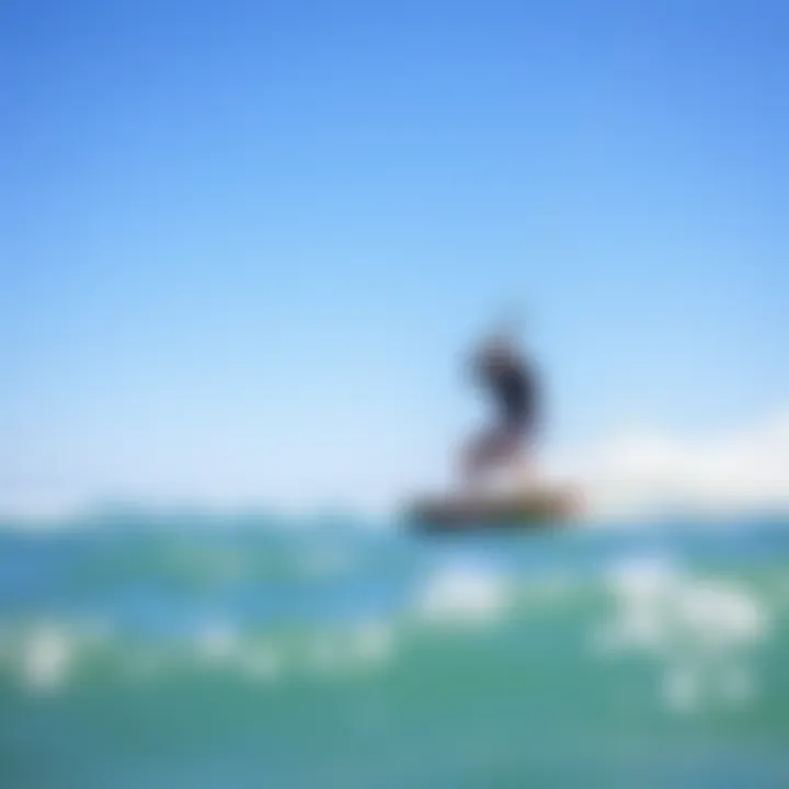 Riding the Waves: The Thrill of Kitesurfing A kitesurfer riding a wave against a backdrop of clear blue skies