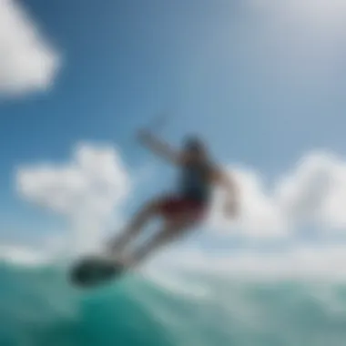 Kiteboarder riding the waves under a clear blue sky