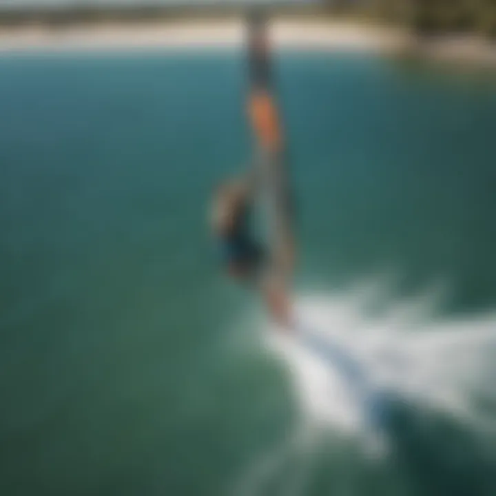 Aerial view of a kiteboarder performing a back roll over water