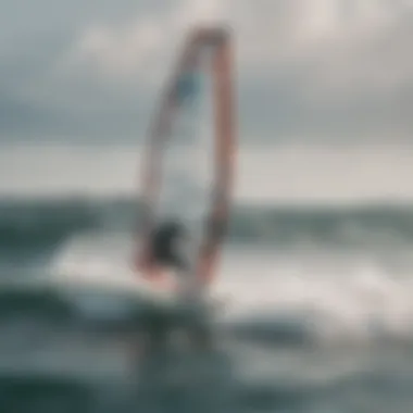 A skilled windsurfer performing a maneuver above waves