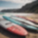 A variety of surf foil boards displayed on a beach