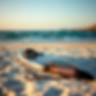 A pristine beach setting with a prone foil board and kiteboarding gear laid out