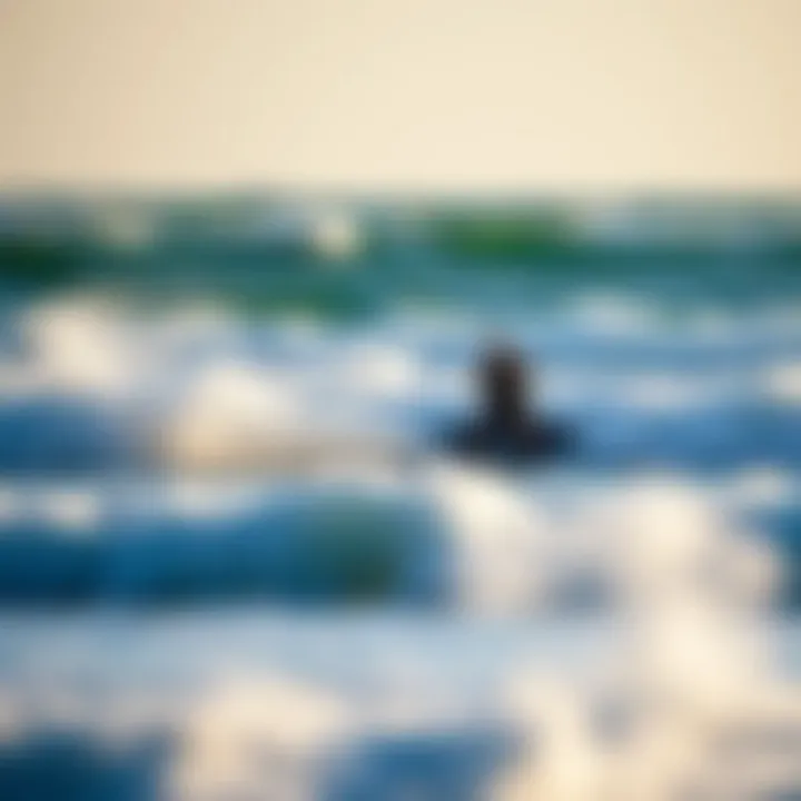 Waves crashing on the shore with a kiteboarder navigating the water