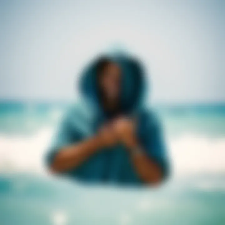 Kiteboarder changing clothes discreetly with a hooded change towel