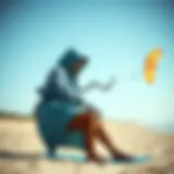 Kiteboarder using a hooded change towel on the beach