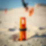 A close-up view of a kite ground stake embedded in sand, showcasing its robust design.