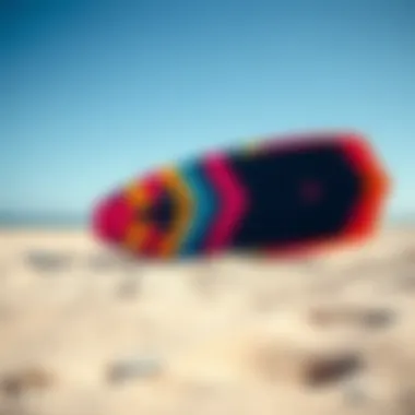 Kite Surf Board on the Beach A vibrant kite surf board displayed on a sandy beach under a clear blue sky
