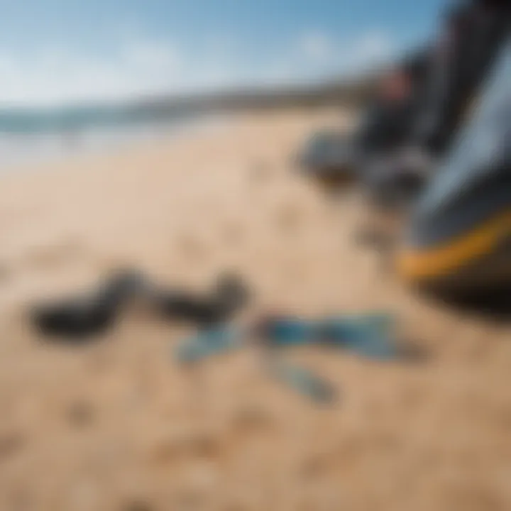 A close-up of essential kite surfing gear laid out on the sandy beach