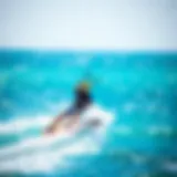 A kitesurfer gliding over turquoise waters