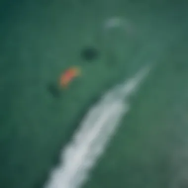 An aerial view of kite surfers riding the waves in crystal-clear waters