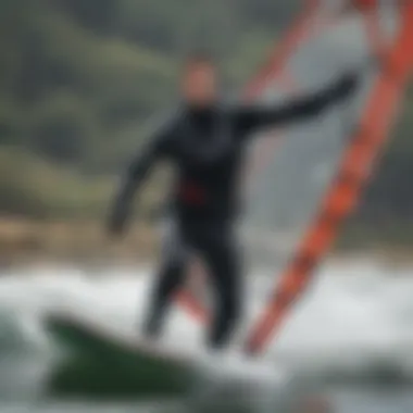 A windsurfer navigating through choppy waters wearing a dry suit