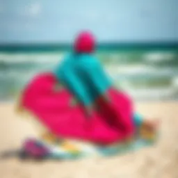 A vibrant poncho draped over a kiteboard on a beach
