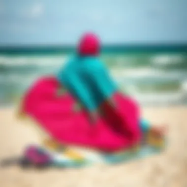 A vibrant poncho draped over a kiteboard on a beach