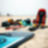 Kitesurfing equipment laid out on a sandy beach