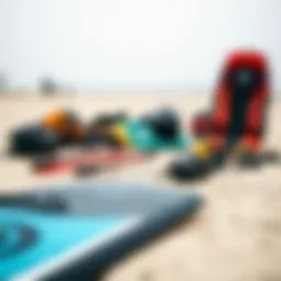 Kitesurfing equipment laid out on a sandy beach