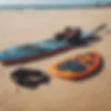 Kite surfing equipment laid out on a sandy beach