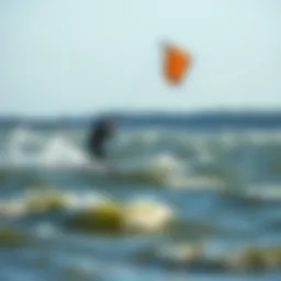 Kiteboarder gliding across the Falmouth waters during high tide