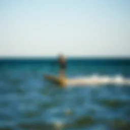 A person gliding effortlessly over water on a wingfoil setup, showcasing balance and skill.