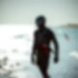 Kiteboarder in a modern wet suit by the shore