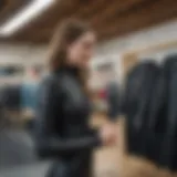 A tall woman trying on a wetsuit in a store