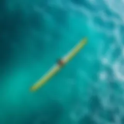 An aerial view of a wingfoiler gliding over clear turquoise waters